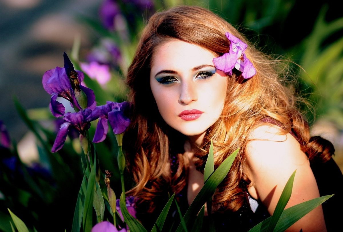 Beautiful lady on purple flower is amazed